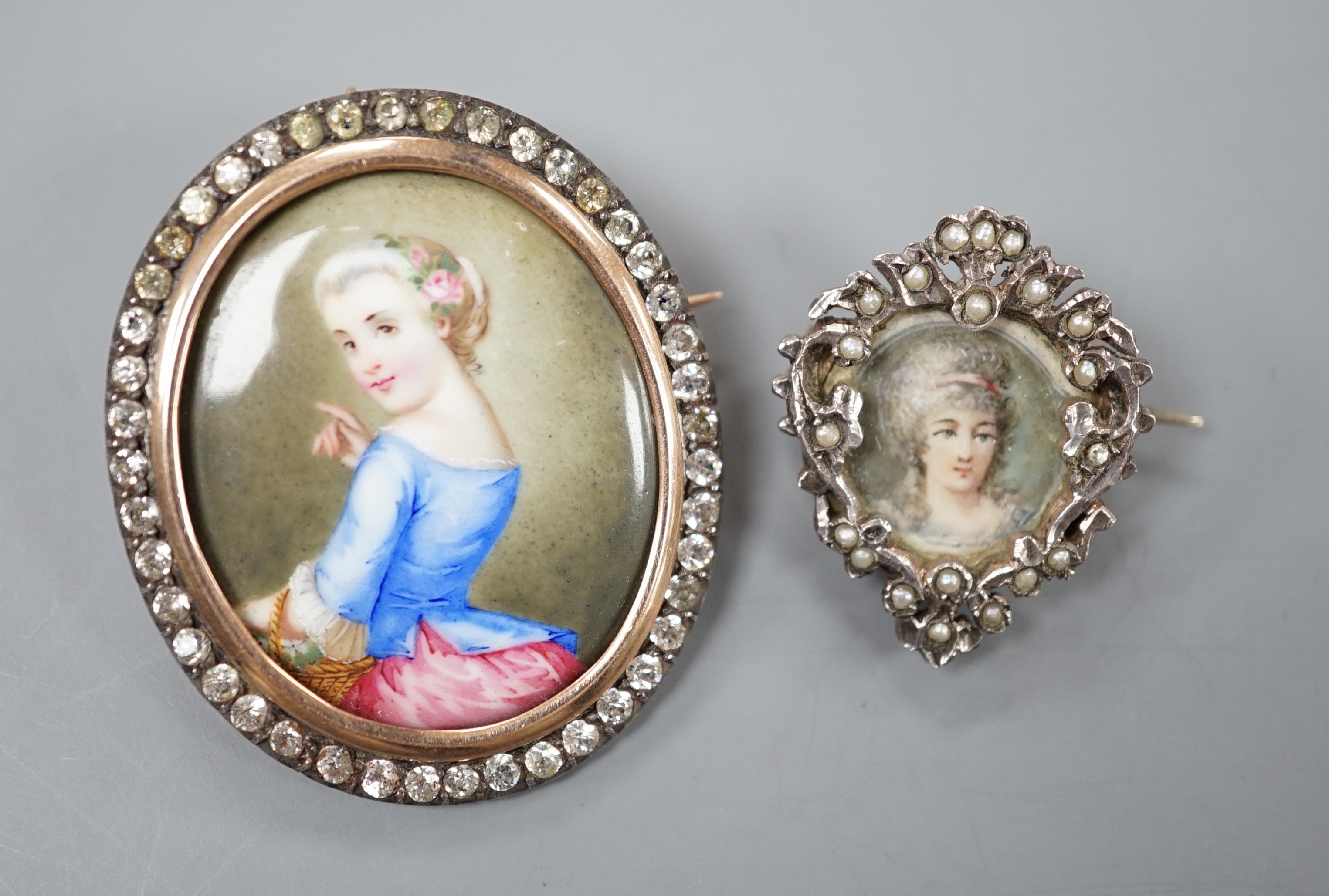 A Victorian yellow and white metal and paste set oval miniature brooch, 41mm and a small circular seed pearl set miniature brooch.